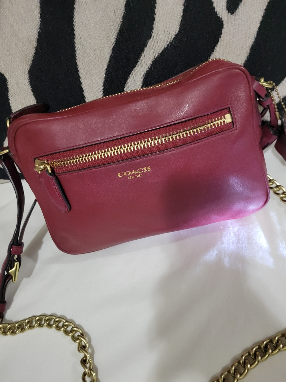 Coach Leather Crossbody Bag in Deep Berry with Gold Hardware.